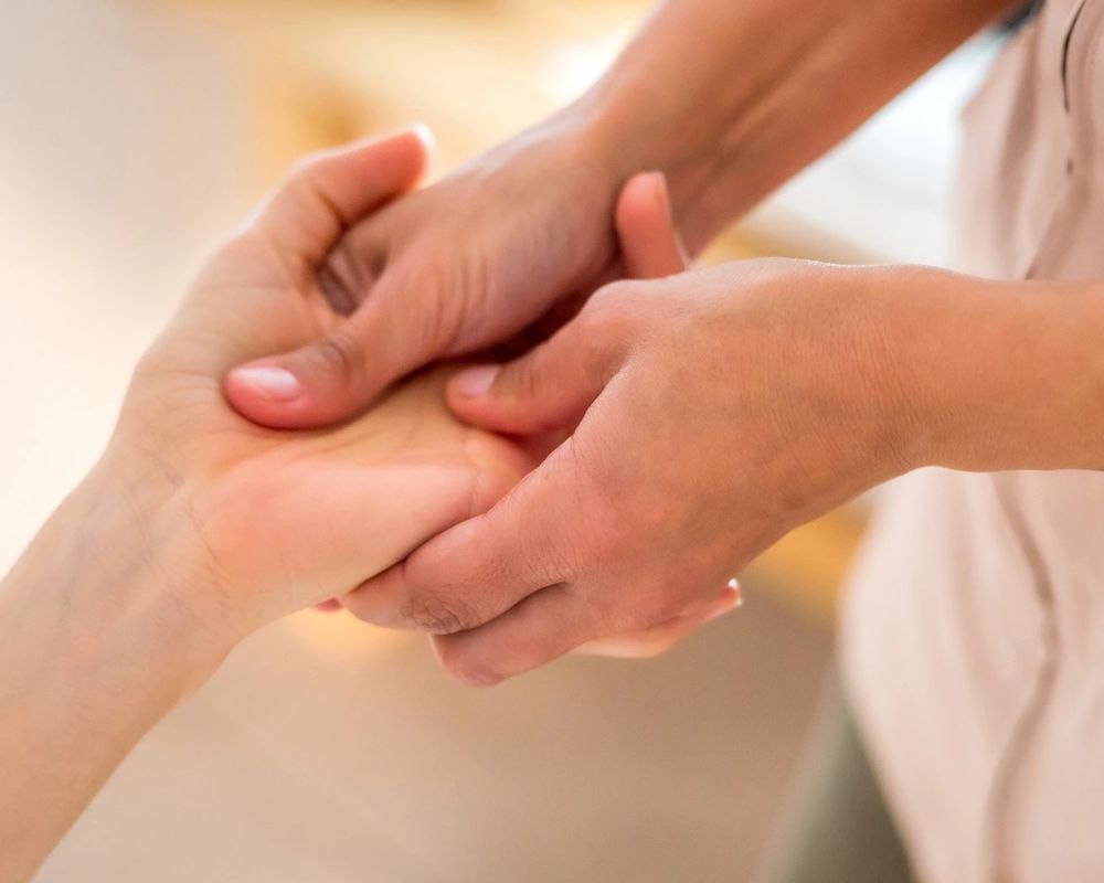 Therapeutic massage practitioner providing gentle hands-on bodywork