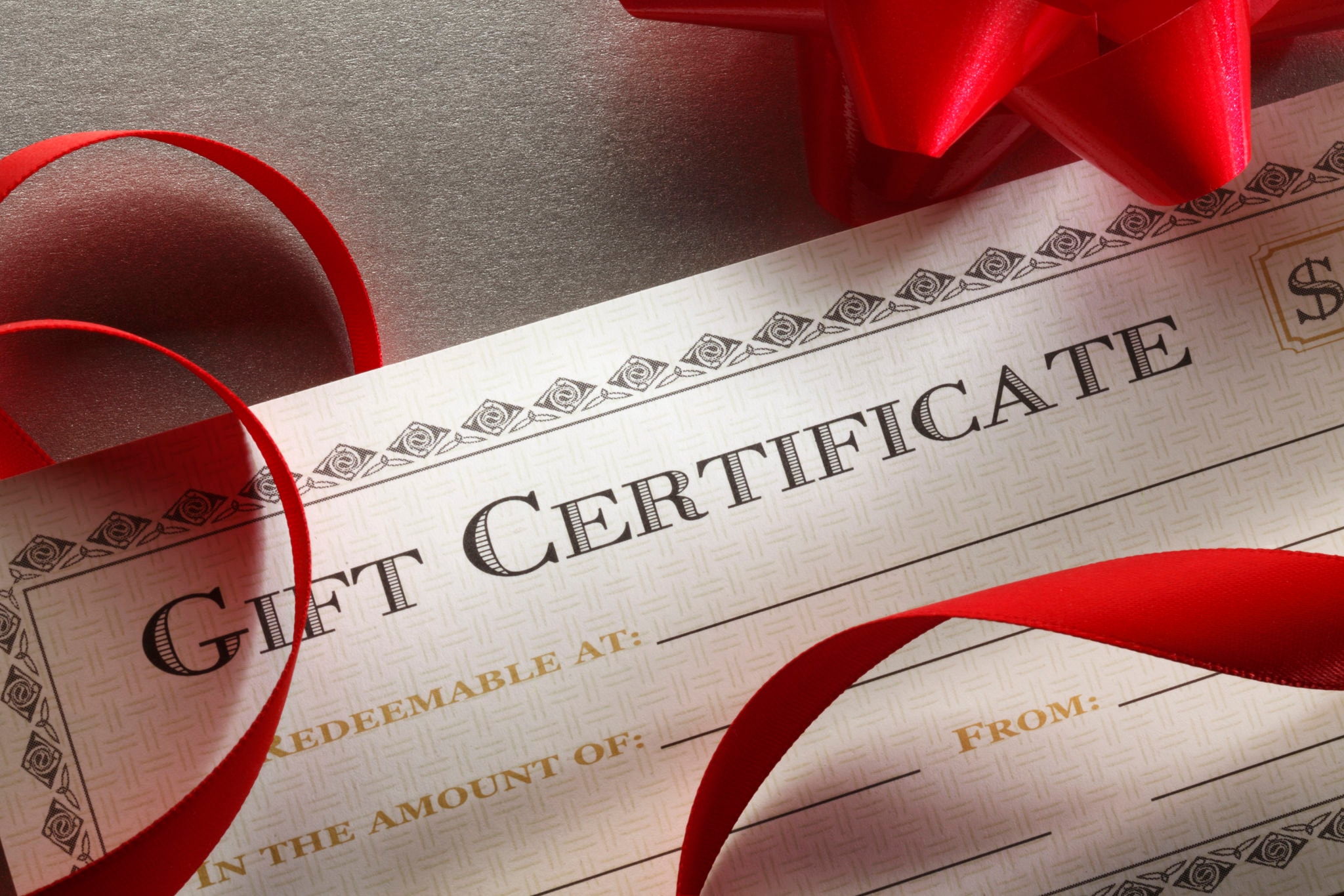 Gift certificate tied with a red ribbon